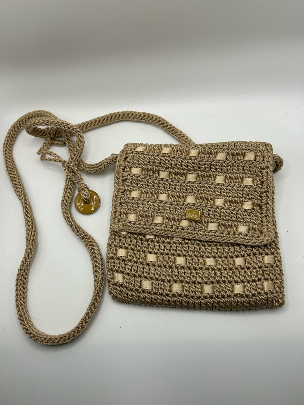 The Sak tan macrame crochet style flap crossbody purse